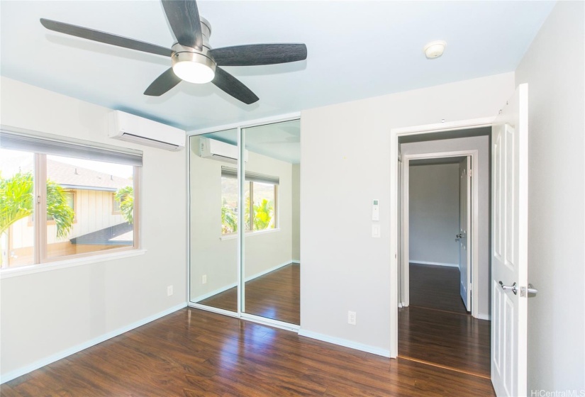 upstairs bedroom with spit ac & ceiling fan