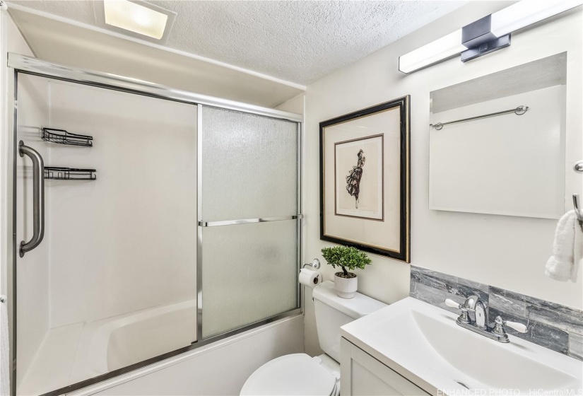 There is a linen closet right outside the bathroom. New lighting fixture and mirror. Enhanced