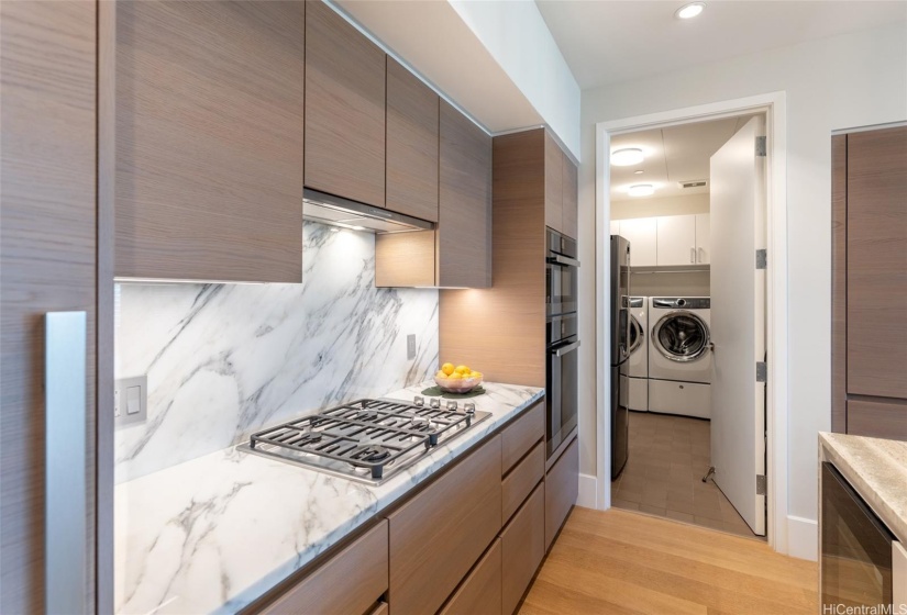 Upgraded Studio Becker cabinetry with marble counter and backsplash.