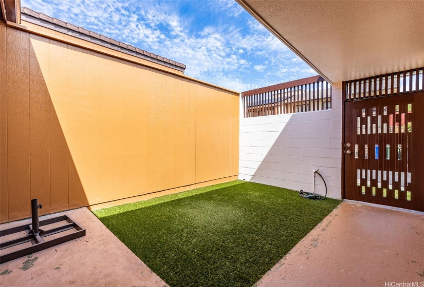 Secured front courtyard with turf grass