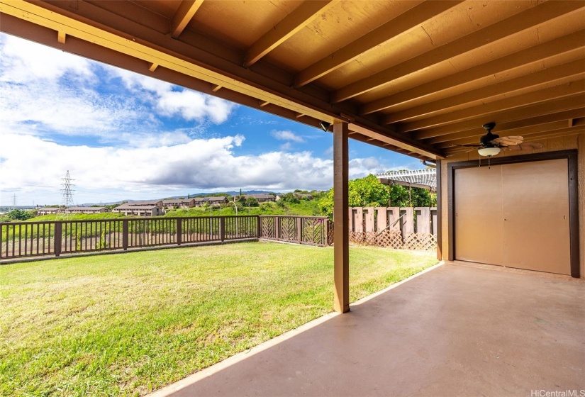 Generous covered patio area with a sizable back yard