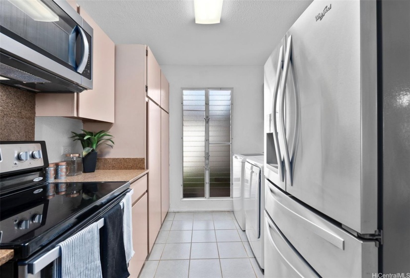 Considerable galley kitchen with washer and dryer