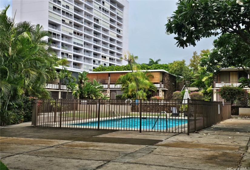 Pool area as you enter from Heulu Street. Very well-maintained pool! Subject property is in the building centered in this photo, second unit from the corner, ground floor.