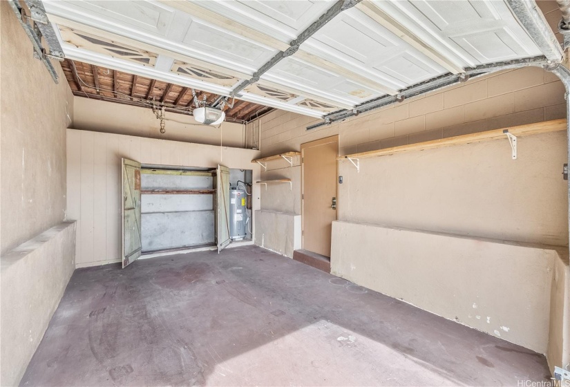 Enclosed garage has a high ceiling, a nice storage closet with a newer water heater inside.