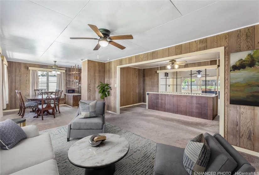 This is the view from the front door. Dining area is on the left and stairs to the downstairs area can be seen towards the back. Enhanced/ virtually staged.