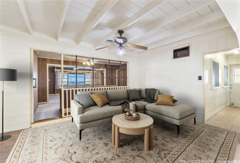 This middle room was the original enclosed lanai area. Enhanced/ virtually staged as a TV room.