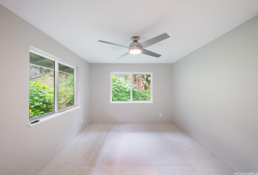 Bedroom 2, tons of natural light and views of the lush backyard.