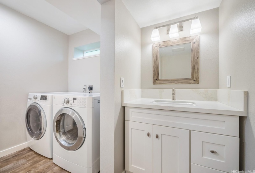 Bathroom is easily accessible for guests near the kitchen.