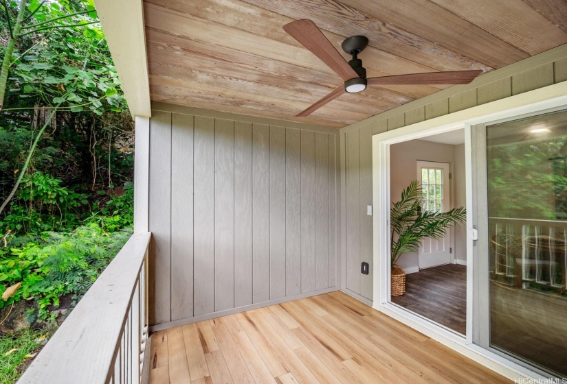 Lanai off of the dining room with vinyl flooring.