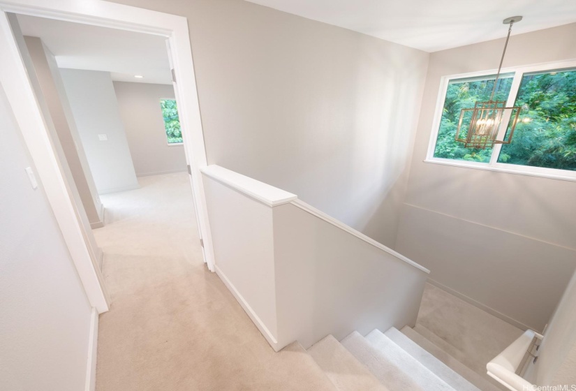 Lots of natural light on stairs, looking towards the primary bedroom