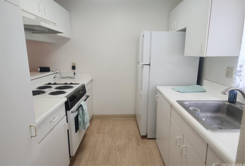 Galley kitchen with lots of cabinets.