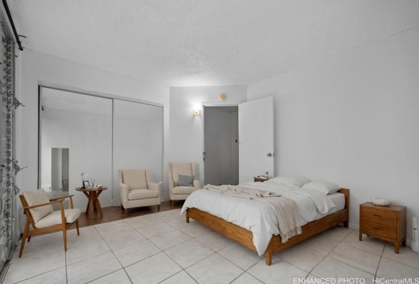 Enhanced photo of the primary bedroom with virtual staging.