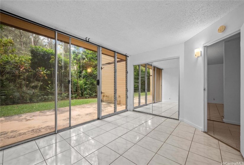 primary bedroom with sliding door leading to the outdoor patio area which is also yours.