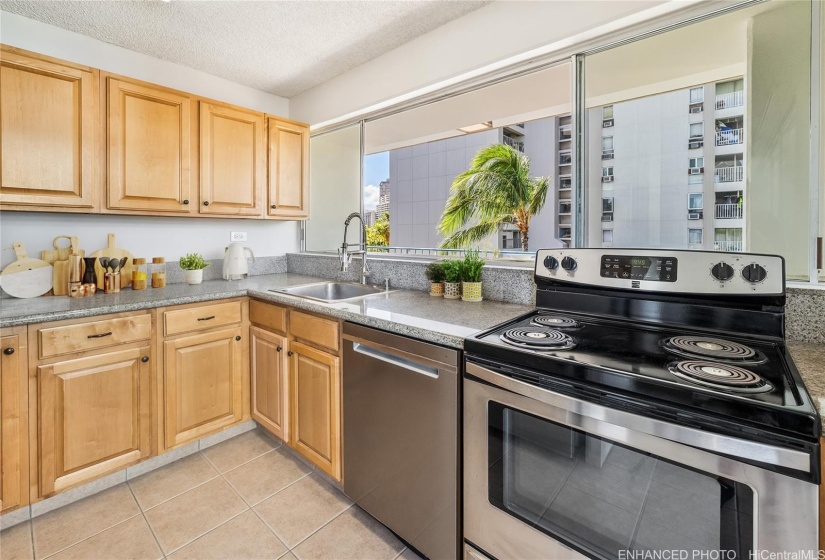 Kitchen with granite counter top, stainless                     steel appliances and pass through to lanai. Enhanced photo. Virtual staging.