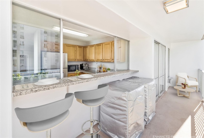 Passthrough from kitchen with bar seating. Enhanced photo. Virtual staging.