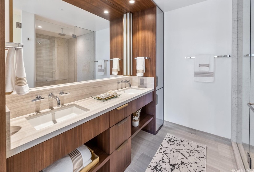 Primary bathroom with custom cabinets and designer lighting.