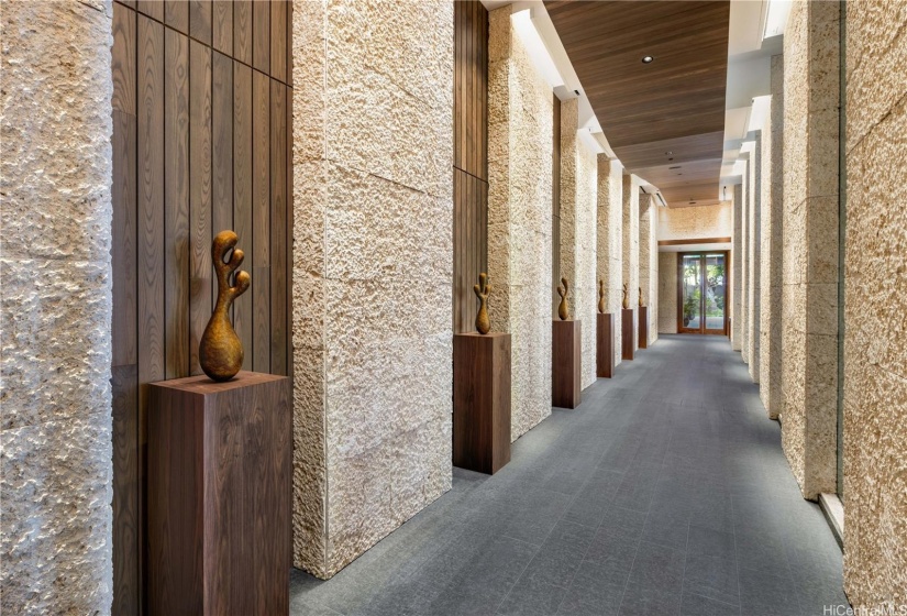 The Gallery - dramatic hallway with voluminous ceilings and art work.