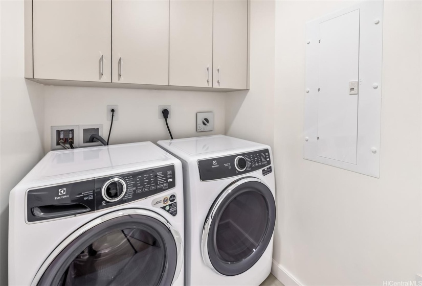 Washer dryer room with full size machines.