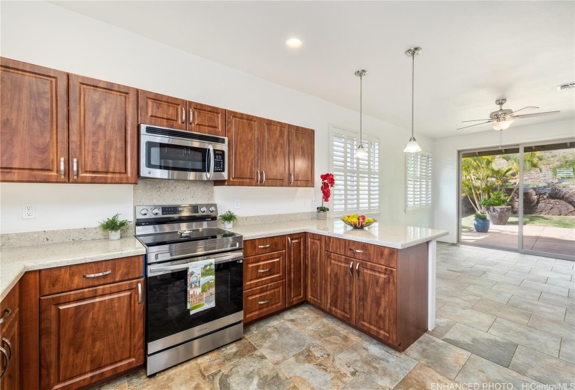 Kitchen with extra dining area & exit to Lanai. Staged. Enhanced photo.