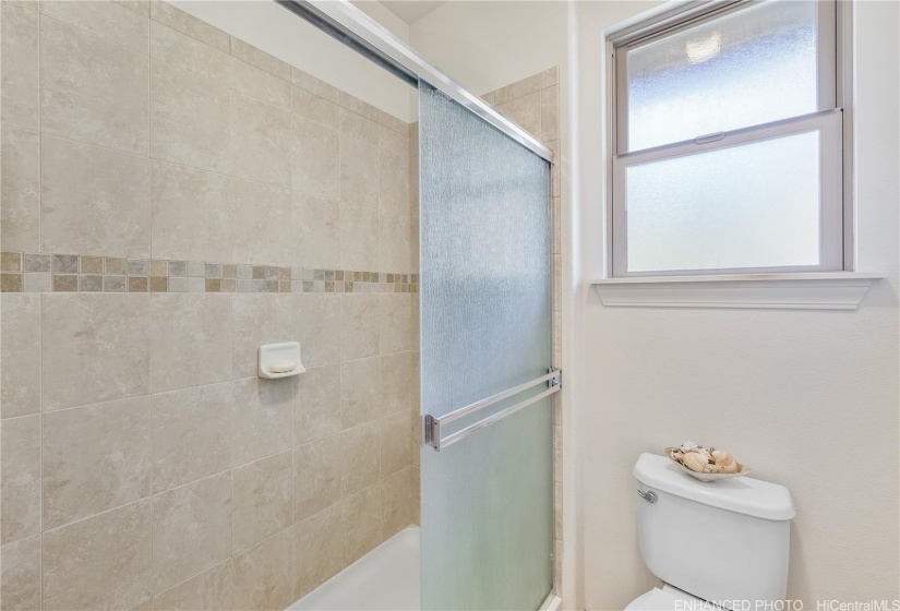 Private walk-in shower in the main bathroom. Staged. Enhanced photo.