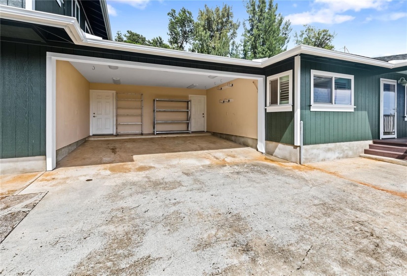 Carport with separate entries to each side of the house. 2 full size truck can fit