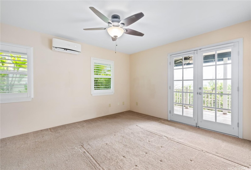 Primary bedroom with access to lanai with a view