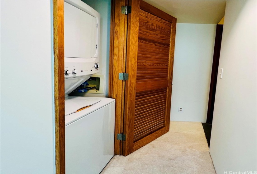 laundry room adjacent to walk-in closet of the primary room