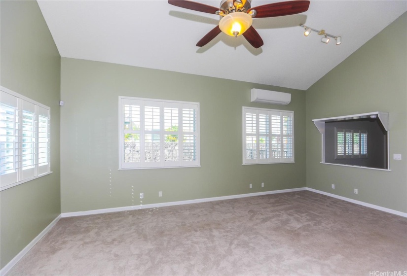 Cool and spacious family room with plantation shutters, ceiling fan, split AC and extra comfy wall to wall carpet.