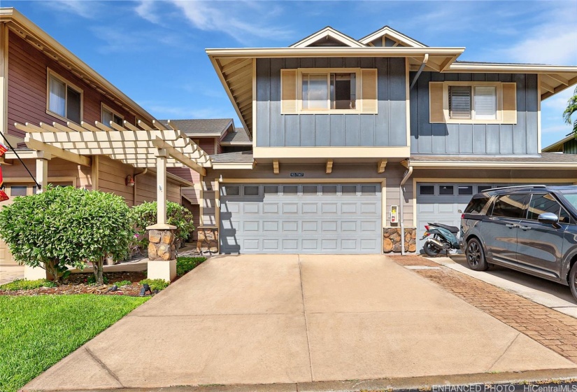 Spacious townhome with two car attached garage and two additional stalls in driveway. This photo has been virtually enhanced.