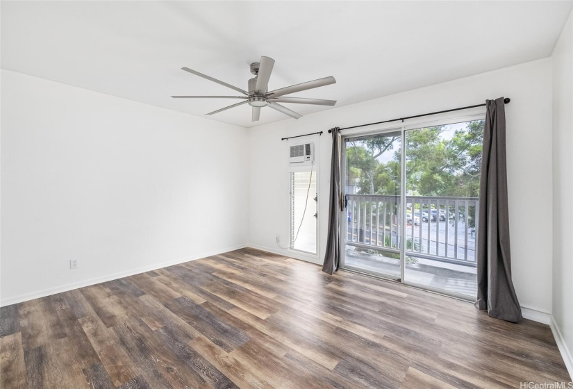 Upstairs is the primary bedroom, also with upgraded flooring and ceiling fan.