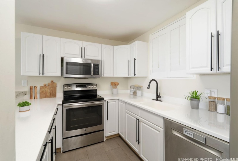 Functional kitchen with lots of counter space. Enhanced: Photo is virtually staged