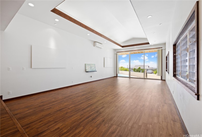 Relax and have fun in this bright, spacious entertainment room with vaulted ceiling.