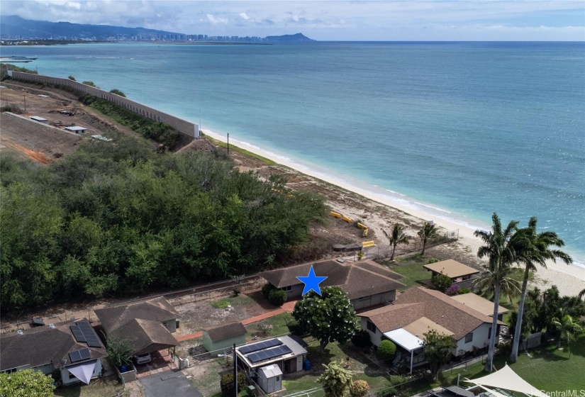 Long parcel fronting sandy beach consists of Main House, Gazebo, Cottage/Carport and Storage Shed.