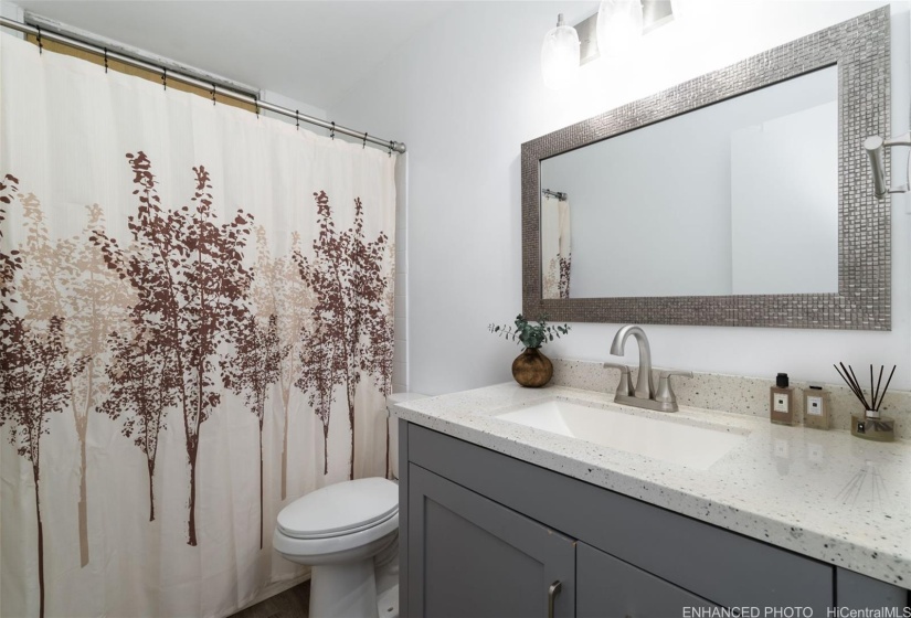 Second bathroom. Enhanced: Photo is virtually staged.