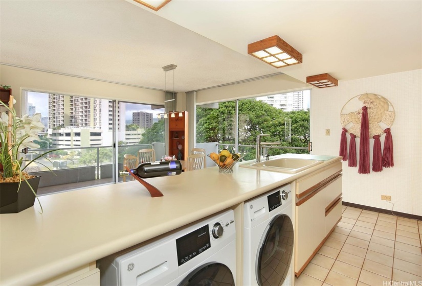 Expansive kitchen island with a brand new washer and dryer.