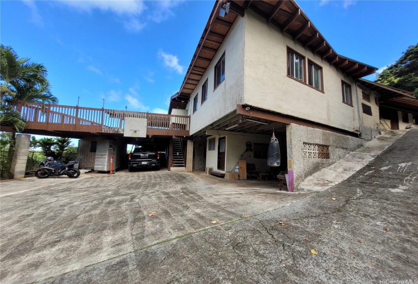 Covered carport with space for additional car parking.