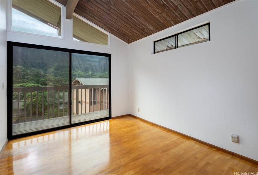 The second bedroom also offers the view, the high ceilings and a deck area.