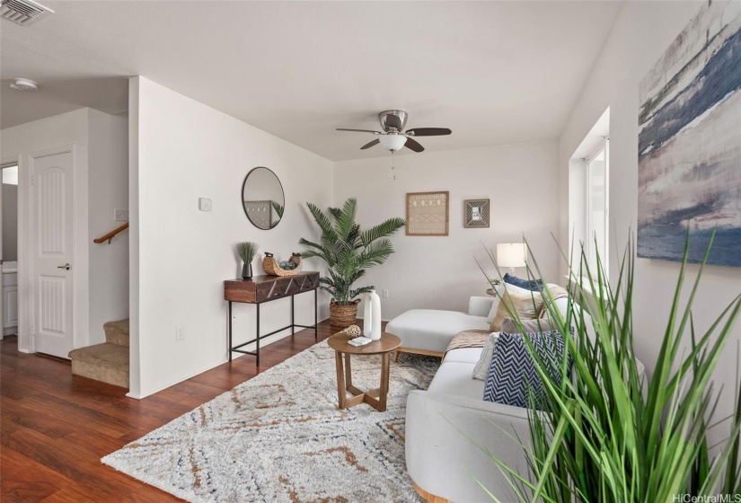 Living room with view of stairs and 1/2 bath