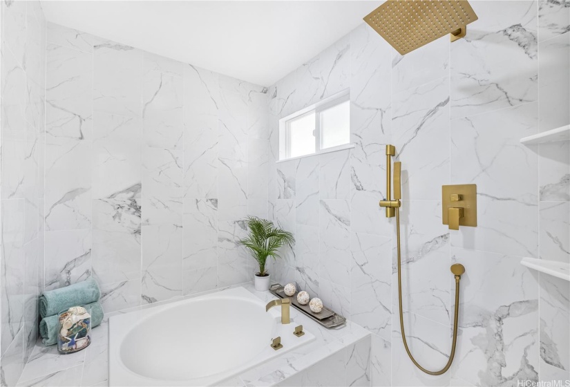 The Primary En-Suite Bathroom includes a European-style bathtub shower room. Enjoy soaking in the deep tub and then showering with the rainforest shower head.