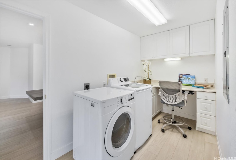 The laundry room includes a desk and storage.