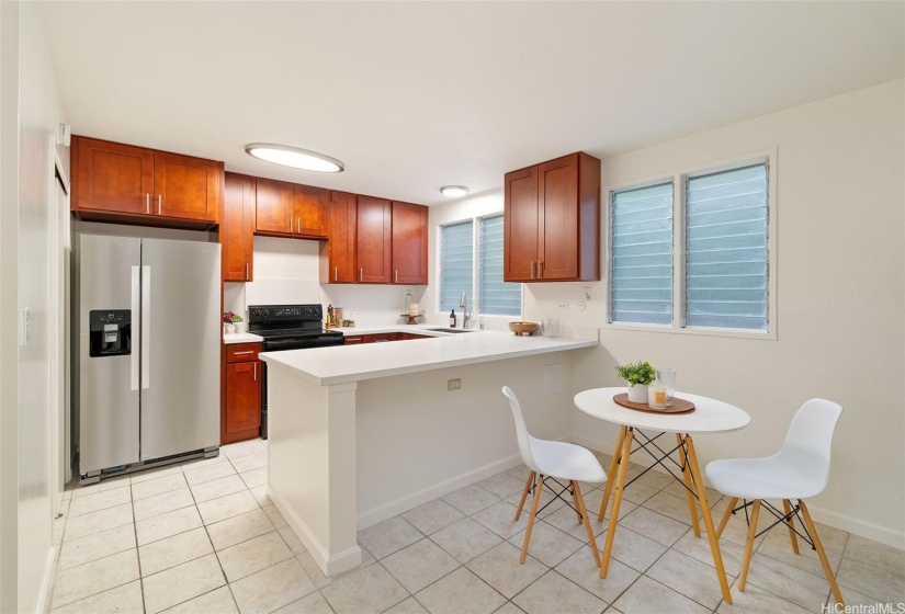 Fully renovated kitchen with bar and space for dining table