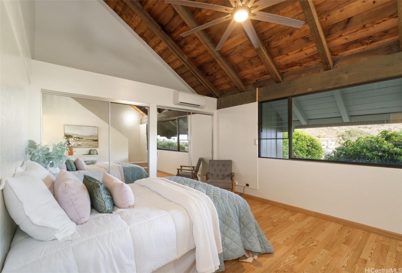 Primary bedroom with soaring ceilings and large closets.