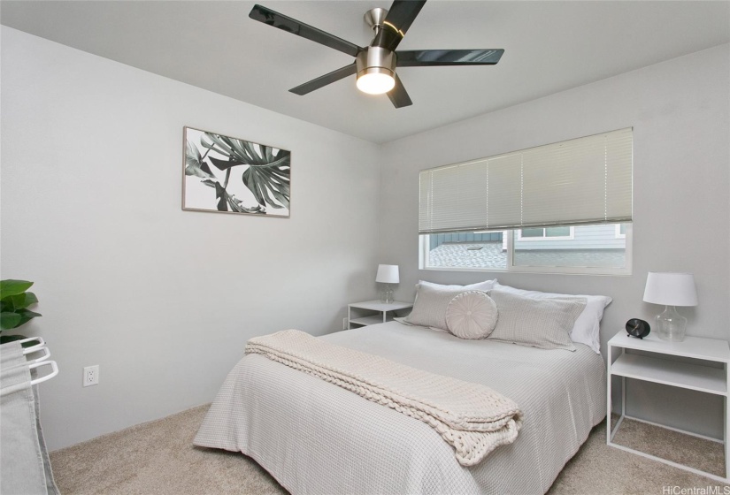 Primary bedroom with split AC and ceiling fan