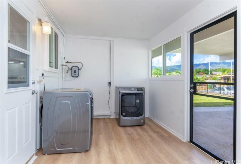 Between the carport and kitchen is a roomy utility room with lots of pantry or storage space