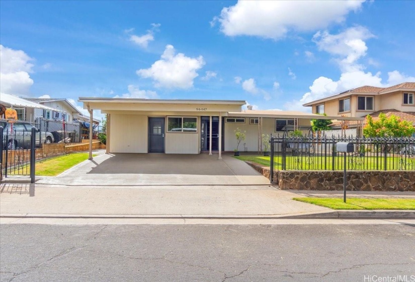 Carport and driveway with gate open