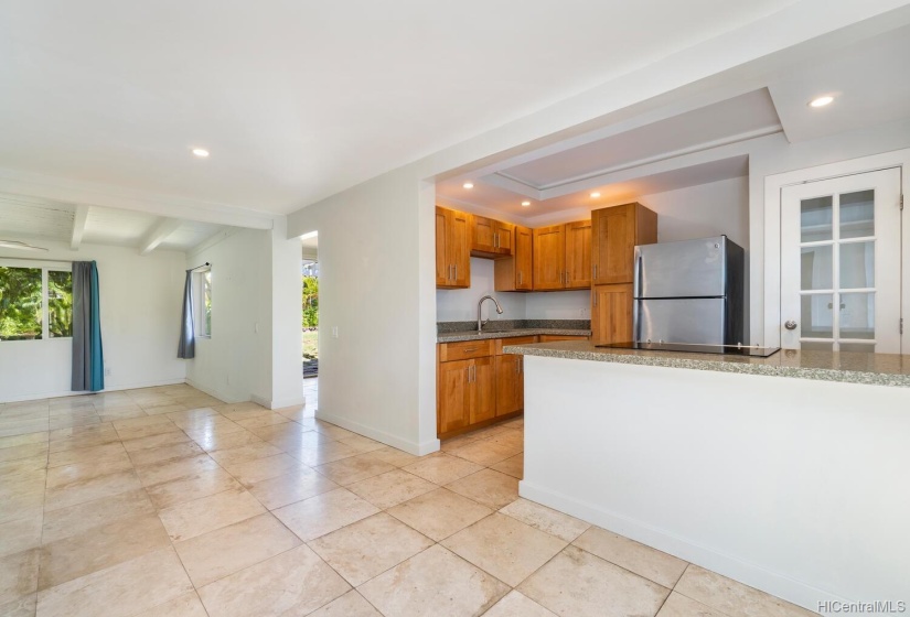 Open kitchen with nicely finished cabinetry.