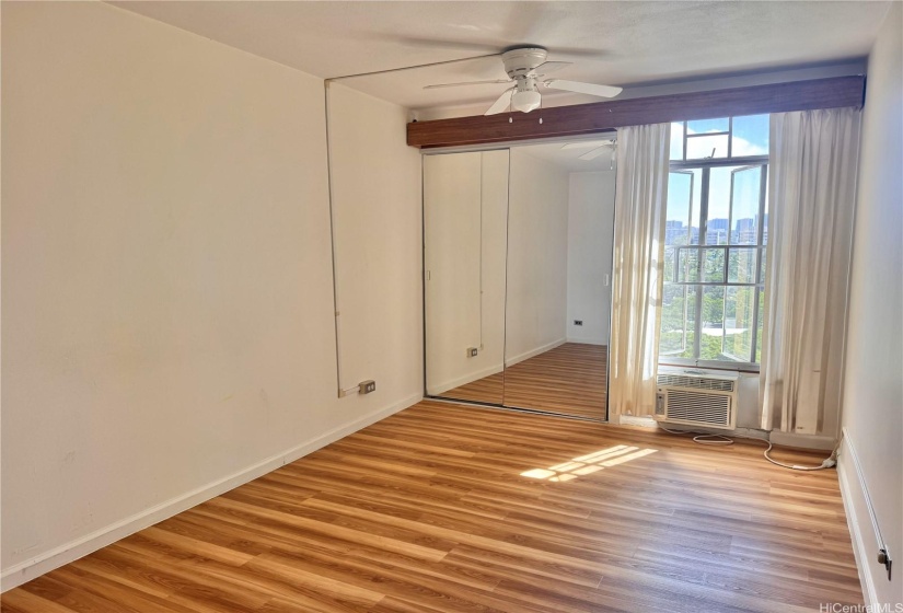 Bedroom offers both a ceiling fan and a window AC.