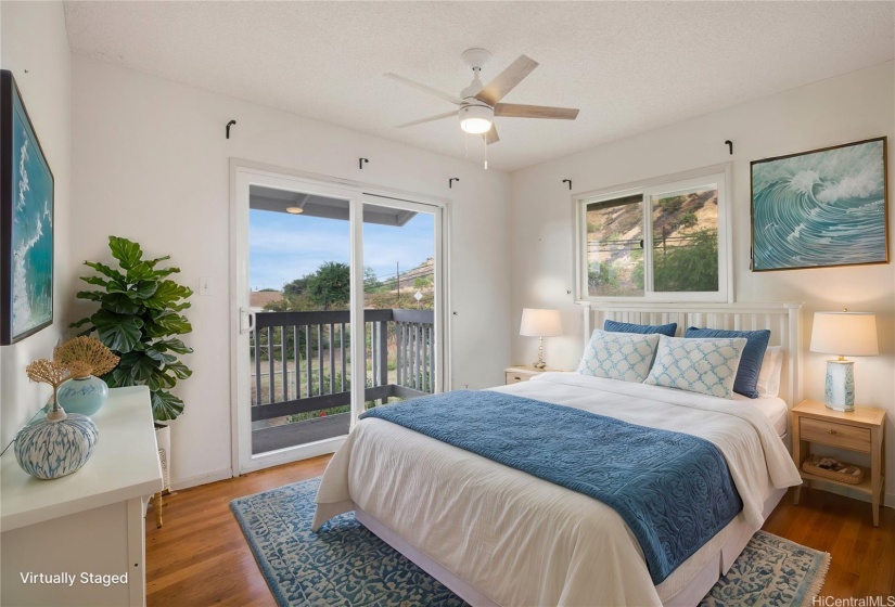 VIRTUALLY STAGED. This cozy upstairs bedroom features a private balcony. The balcony adds a touch of outdoor charm and extends the living space.
