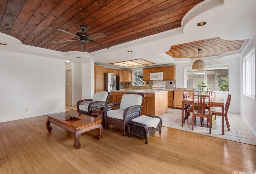 This inviting open-concept space seamlessly combines the living room and kitchen, creating a perfect area for family gatherings and entertaining. The kitchen features a large island counter, ideal for meal prep and casual dining.