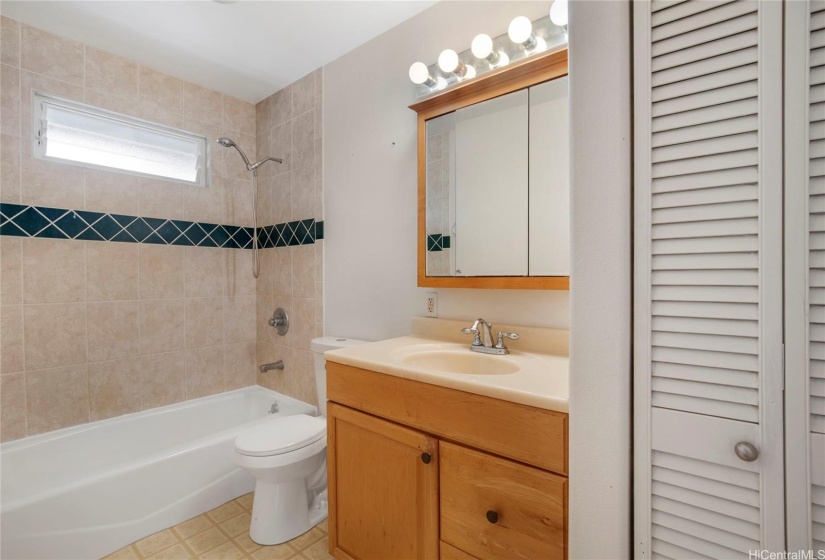 This primary bathroom offers ample storage space, ensuring all your essentials are neatly organized. The thoughtful design combines functionality with style, creating a comfortable and clutter-free environment.